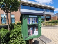 green wood box filled with books