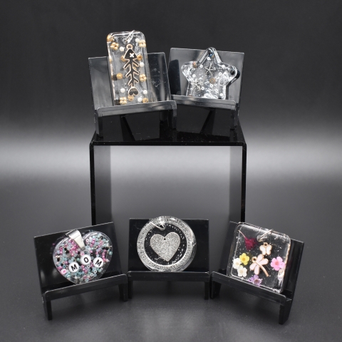 Resin pendants with beads and charms embedded inside.