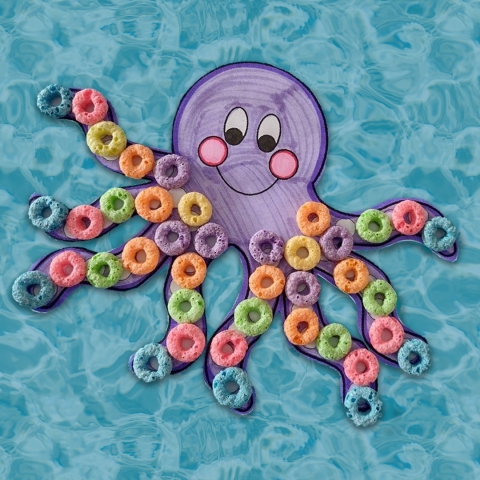 hand-colored paper octopus with Fruit Loops cereal on its legs against a blue water background