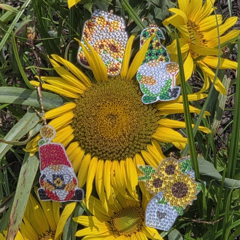 Yellow sunflowers with gem-covered keychains in the sun.