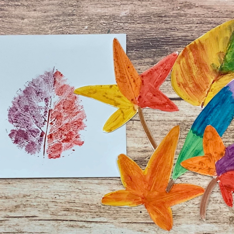 photo of leaves painted in bright colors and pressed onto paper