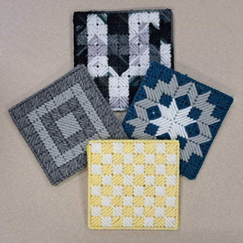 photo of blue, gray and yellow coasters made from plastic canvas