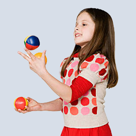 photo of a young girl juggling