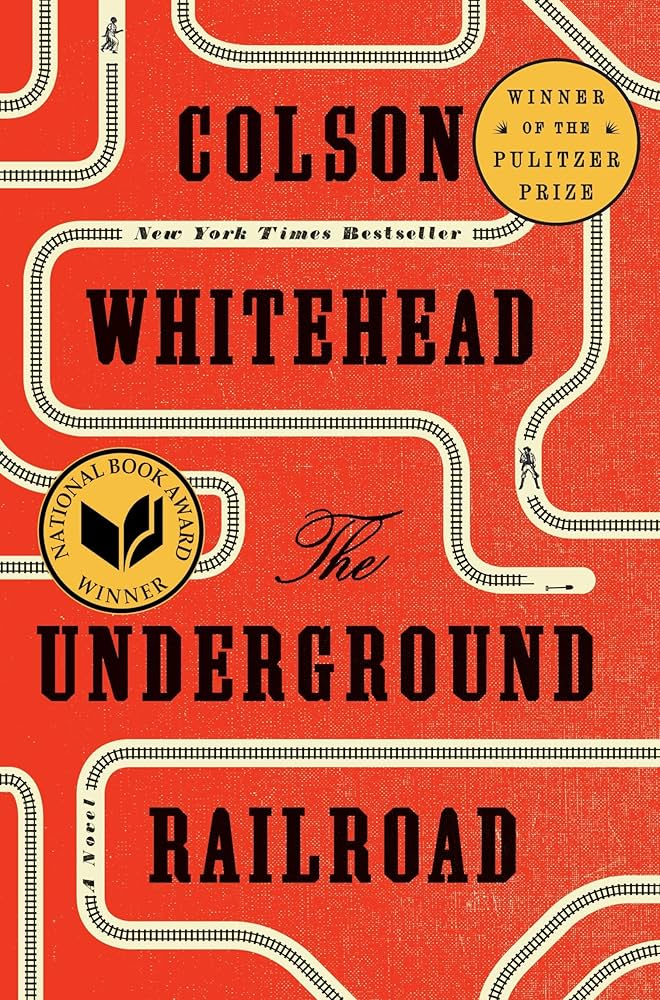 The Underground Railroad book cover red with white train tracks black text gold award medals